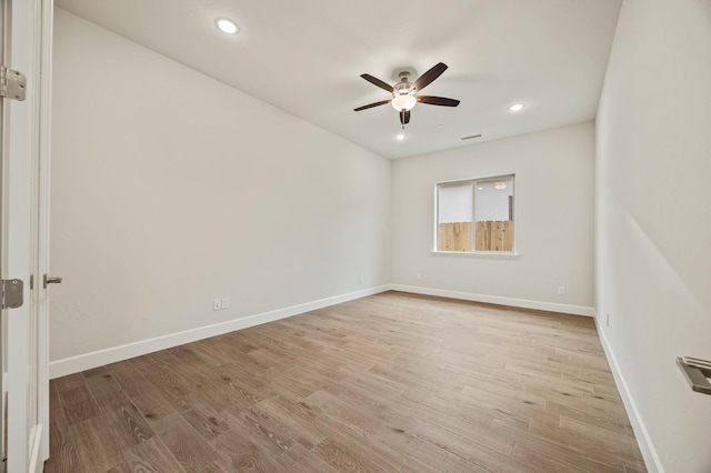 spare room with recessed lighting, wood finished floors, visible vents, baseboards, and ceiling fan
