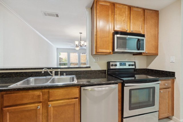7178 N Fruit Ave Unit 132, Fresno, CA 93711 - kitchen with stainless steel appliances, dark stone countertops, visible vents, a sink, and brown cabinetry