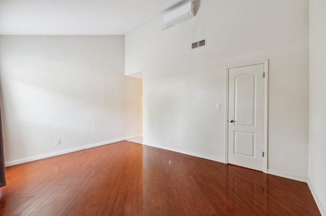7178 N Fruit Ave Unit 132, Fresno, CA 93711 - empty room with a towering ceiling, wood finished floors, visible vents, and baseboards