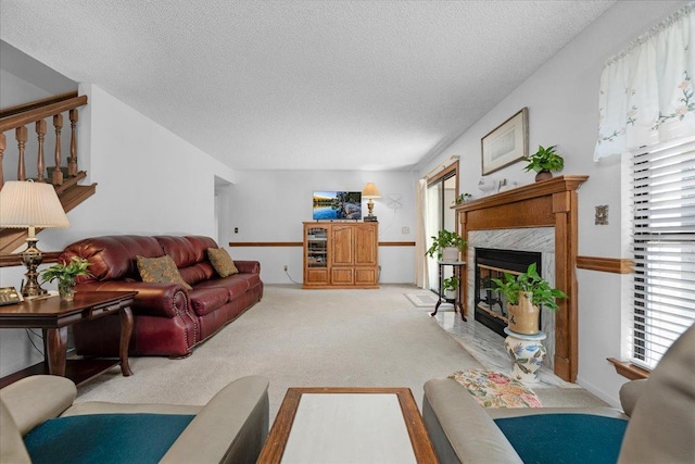 1607 E Everglade Ave, Fresno, CA 93720 - living area with light carpet, a textured ceiling, a fireplace, and healthy amount of natural light