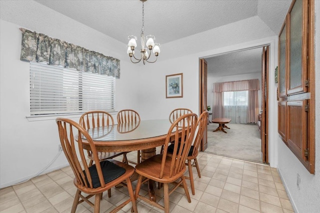 1607 E Everglade Ave, Fresno, CA 93720 - dining area with a textured ceiling, a chandelier, and baseboards