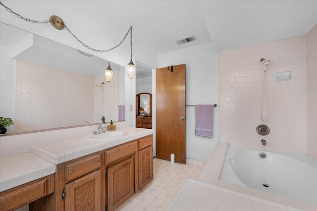 1607 E Everglade Ave, Fresno, CA 93720 - bathroom with vanity, tile patterned floors, and tiled shower / bath