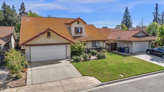 1607 E Everglade Ave, Fresno, CA 93720 - view of front of property featuring stucco siding, driveway, a tile roof, a front lawn, and an attached garage