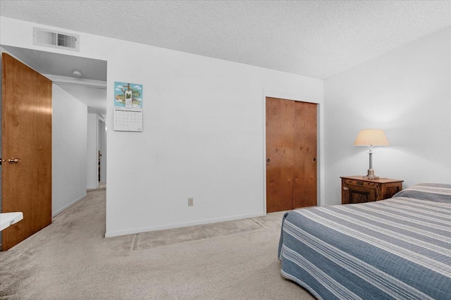 1607 E Everglade Ave, Fresno, CA 93720 - bedroom featuring carpet flooring, a closet, baseboards, and a textured ceiling