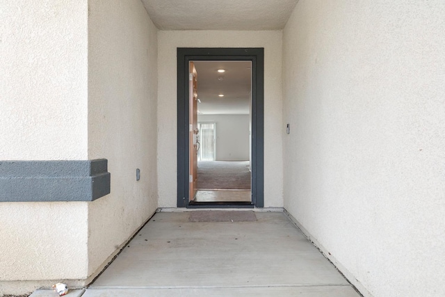 entrance to property featuring stucco siding