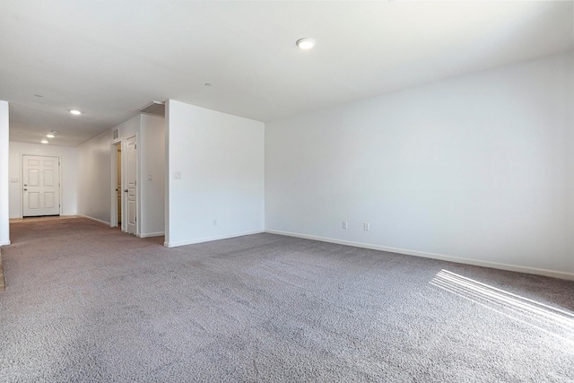 unfurnished room featuring carpet floors, baseboards, and recessed lighting