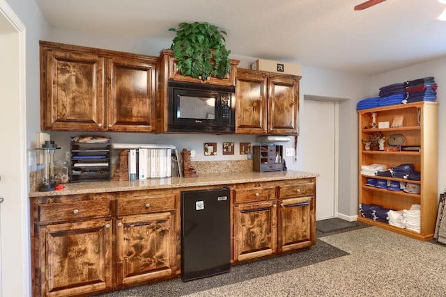 bar with black microwave, a ceiling fan, and dark colored carpet
