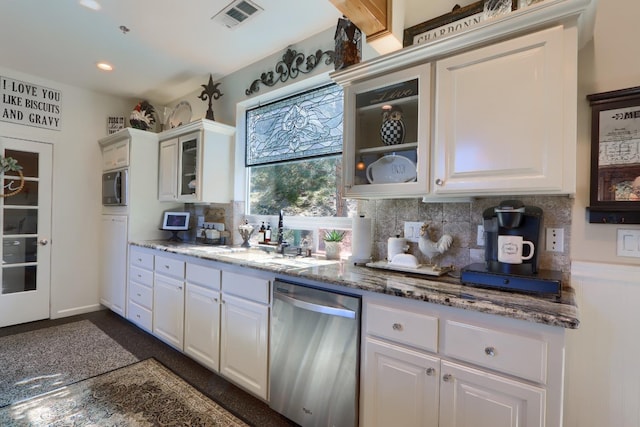 kitchen featuring white cabinets, stainless steel appliances, tasteful backsplash, and visible vents