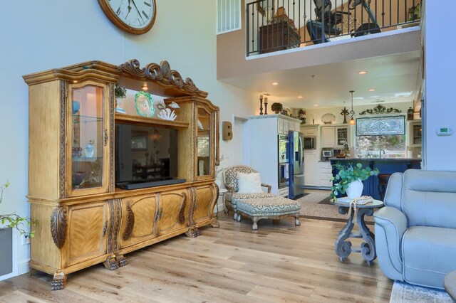 42038 Empty Creek Rd, Oakhurst, CA 93644 - living area featuring light wood-type flooring and a towering ceiling