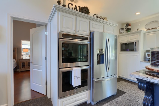 kitchen featuring visible vents, recessed lighting, white cabinetry, light stone counters, and appliances with stainless steel finishes