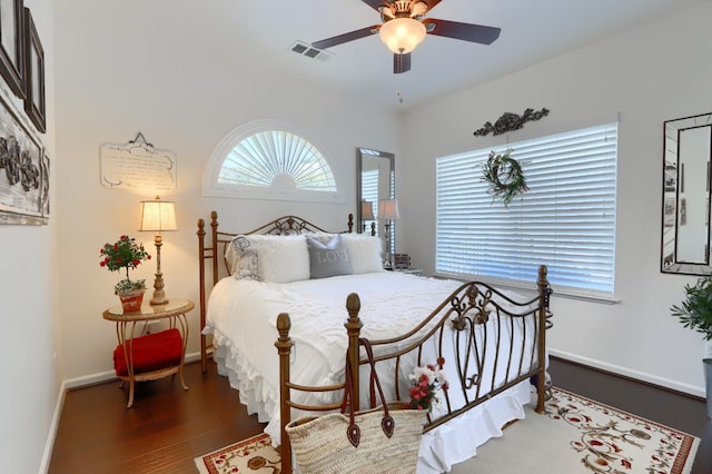 bedroom with visible vents, baseboards, ceiling fan, and wood finished floors
