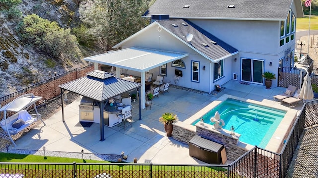 view of pool with a patio, exterior kitchen, a gazebo, and a fenced backyard