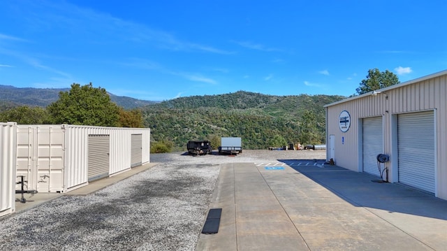 view of road featuring a mountain view and driveway
