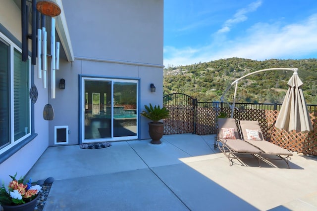 view of patio with a view of trees