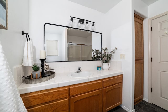full bathroom with tile patterned floors, vanity, a shower stall, and tasteful backsplash