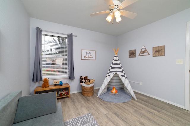 game room with wood finished floors, baseboards, and ceiling fan