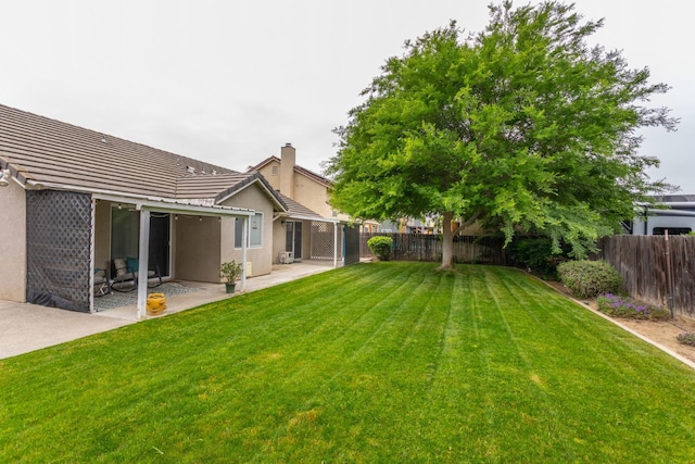 view of yard with a fenced backyard and a patio area