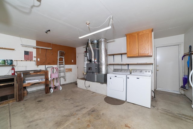 basement featuring heating unit and washer and dryer