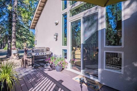 wooden terrace featuring grilling area