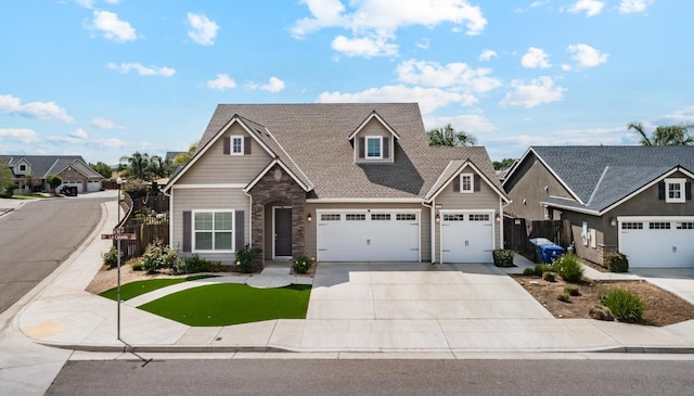 craftsman house featuring driveway, stone siding, fence, a garage, and roof with shingles
