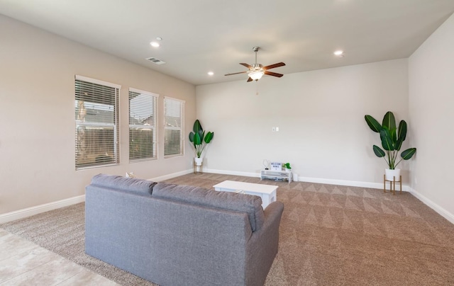 carpeted living room with ceiling fan, baseboards, visible vents, and recessed lighting