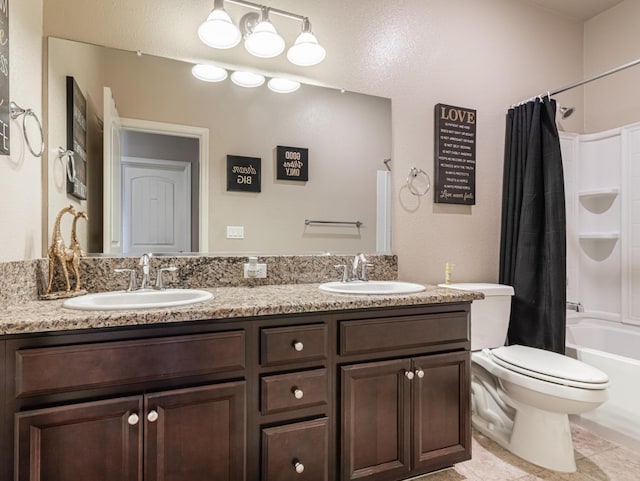 bathroom featuring shower / tub combo, toilet, a sink, and double vanity