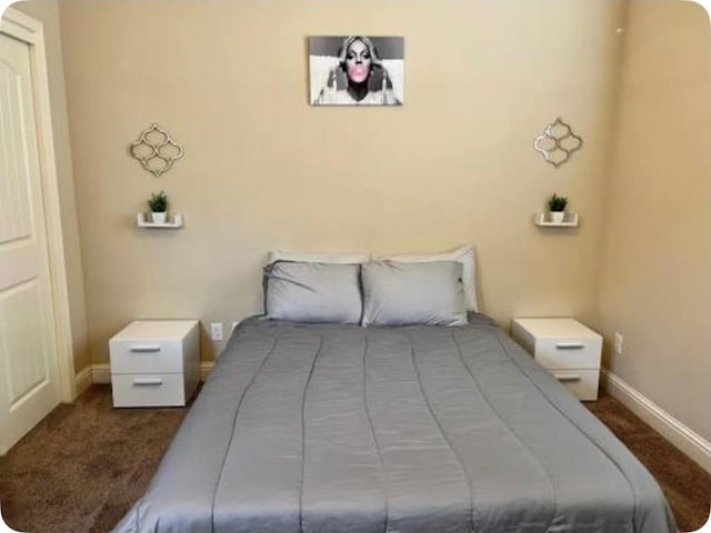 bedroom with carpet floors and baseboards