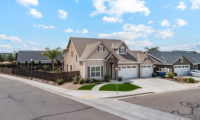 craftsman-style home with a garage, driveway, a shingled roof, and fence