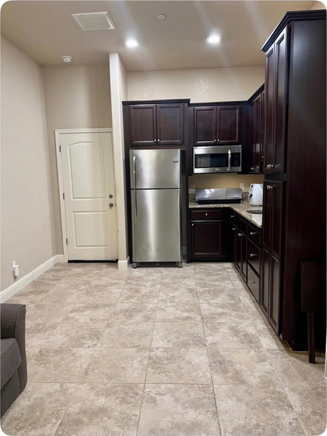 kitchen with baseboards, appliances with stainless steel finishes, dark brown cabinets, and recessed lighting