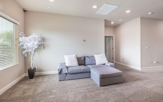 carpeted living room with recessed lighting and baseboards
