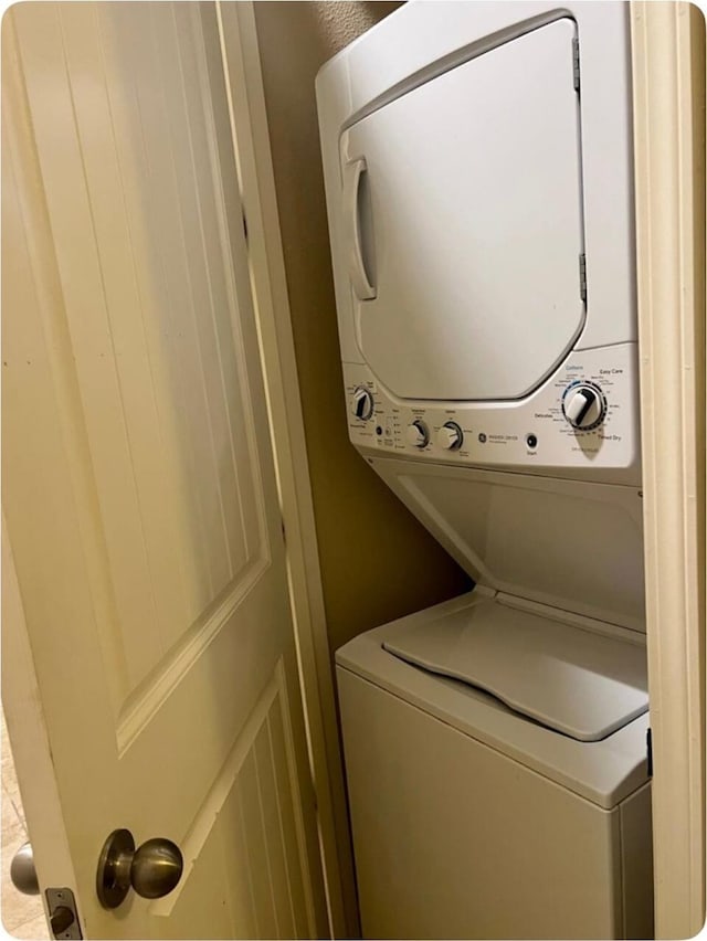 laundry area with stacked washer and dryer and laundry area