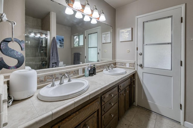 7341 N Bond St, Fresno, CA 93720 - bathroom with a tile shower, double vanity, tile patterned flooring, and a sink