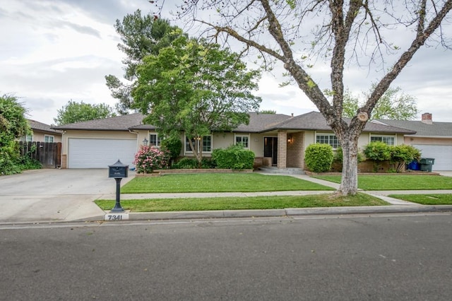 7341 N Bond St, Fresno, CA 93720 - ranch-style house featuring fence, a front lawn, stucco siding, an attached garage, and concrete driveway