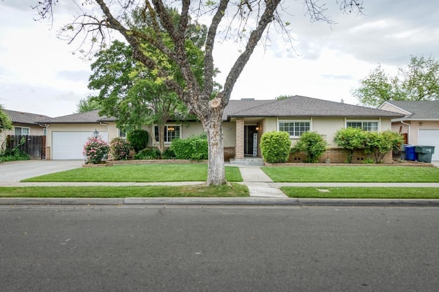 7341 N Bond St, Fresno, CA 93720 - ranch-style home featuring a garage, stucco siding, a front lawn, and concrete driveway