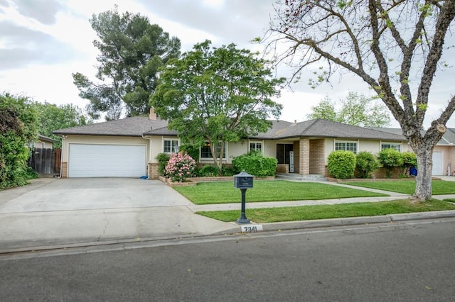 7341 N Bond St, Fresno, CA 93720 - single story home with driveway, brick siding, an attached garage, a front yard, and stucco siding