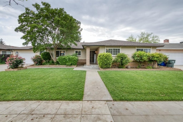 7341 N Bond St, Fresno, CA 93720 - ranch-style house with stucco siding, a shingled roof, a front yard, and a garage