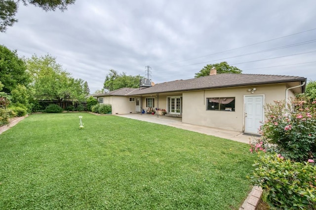 7341 N Bond St, Fresno, CA 93720 - back of property featuring fence, a yard, stucco siding, a patio area, and french doors