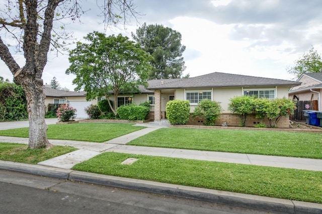 7341 N Bond St, Fresno, CA 93720 - ranch-style home featuring a front lawn, concrete driveway, a garage, a shingled roof, and stucco siding