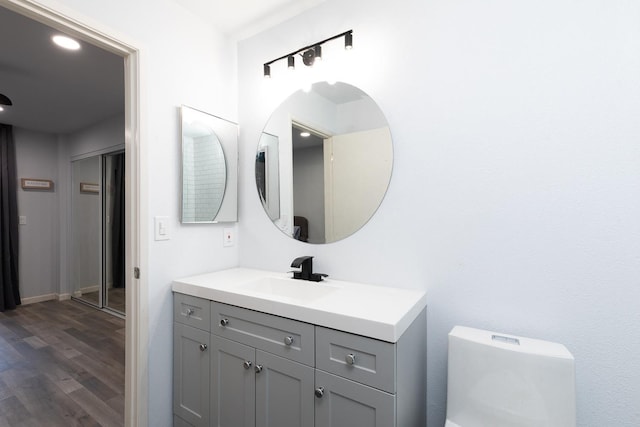 1151 S Chestnut Ave Unit 146, Fresno, CA 93702 - bathroom featuring vanity, toilet, and wood finished floors