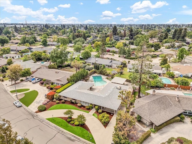 birds eye view of property with a residential view