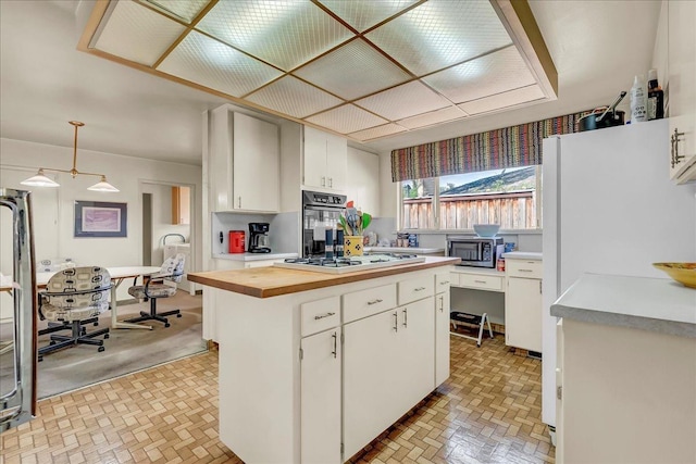 kitchen featuring white cabinets, brick patterned floor, white appliances, butcher block counters, and a kitchen island
