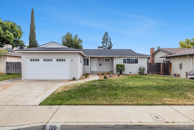 single story home featuring fence, a front lawn, board and batten siding, driveway, and a garage