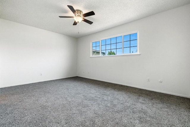 unfurnished room with dark colored carpet, a textured ceiling, a ceiling fan, and baseboards