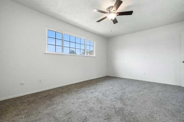 spare room with a textured ceiling, carpet flooring, baseboards, and ceiling fan