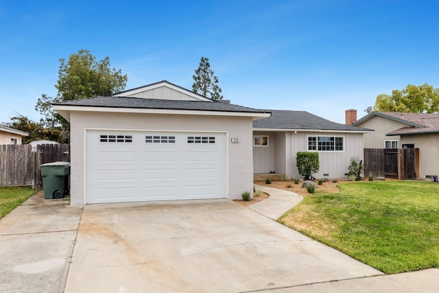 ranch-style house featuring fence, a garage, a front yard, and concrete driveway