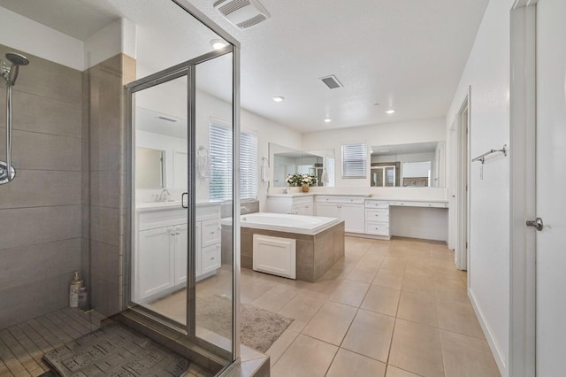 6082 E Homan Ave, Fresno, CA 93727 - bathroom featuring tiled shower, a bath, two vanities, and tile patterned floors