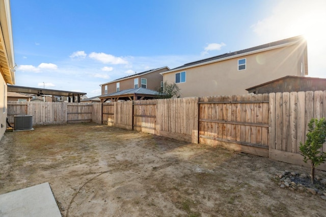 view of yard featuring a fenced backyard and central AC unit