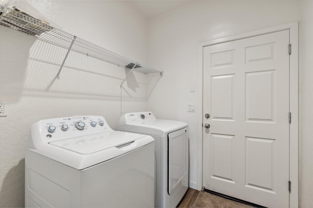 clothes washing area featuring separate washer and dryer and laundry area