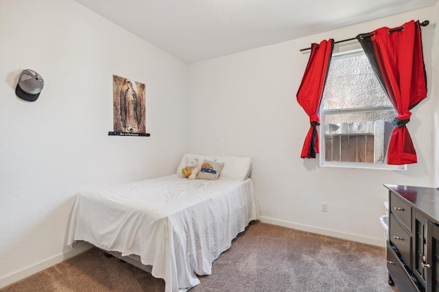 bedroom with baseboards and carpet