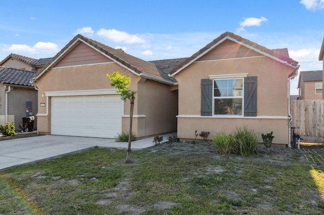 ranch-style house featuring stucco siding, an attached garage, driveway, and fence